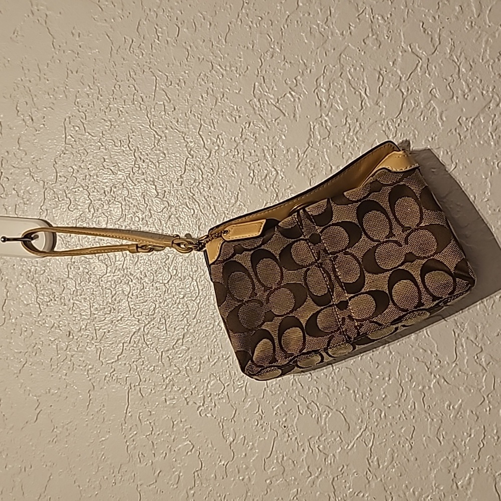 USED TWIST LOCK BROWN/TAN COACH CLUTCH WITH STRAP